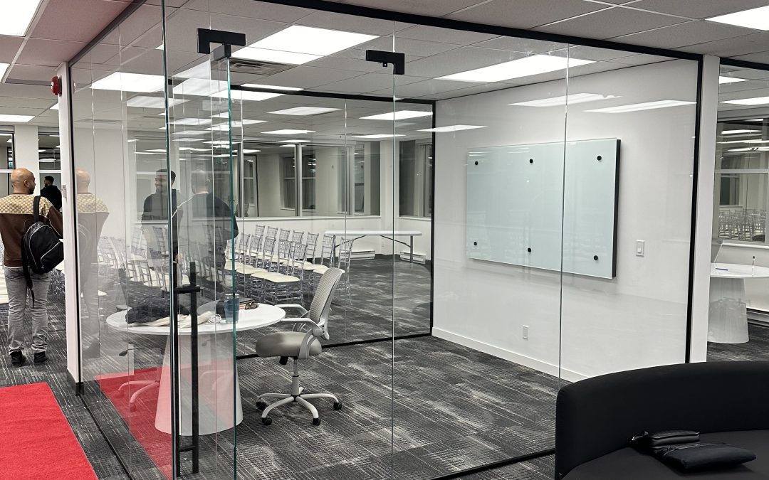 Frameless glass office partition and enclosed meeting room.